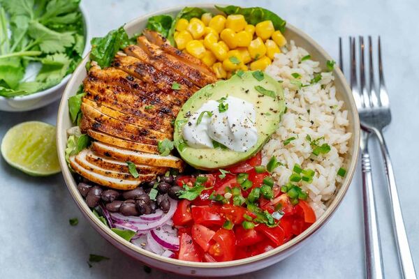 Bowl with greens, grains and vibrant toppings